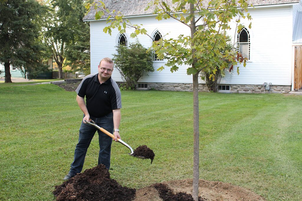 Stephen Blais planting a tree